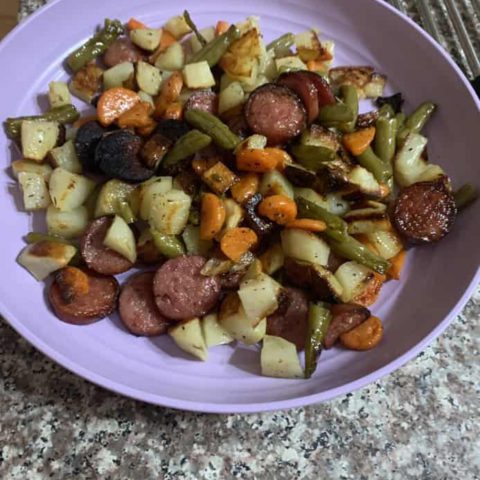 a plate of food with sausage and veggies